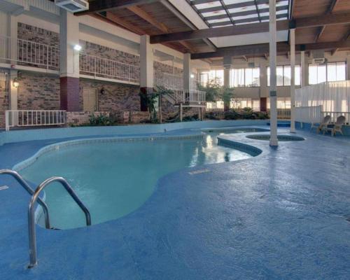 a large swimming pool in a large building at Econo Lodge Conference Center in El Dorado