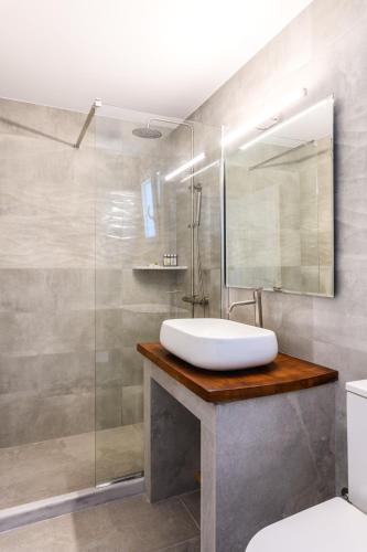 a bathroom with a sink and a shower at Emerald Bay 4BR with pool by Lia Beach in Mikonos