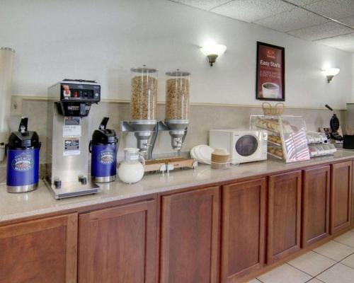 a kitchen with a counter with a microwave and appliances at Econo Lodge Conference Center in El Dorado