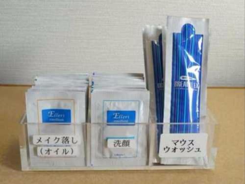 a shelf with packages of toothpaste and toothbrushes at Kawasaki Green Plaza Hotel in Imai-kamichō