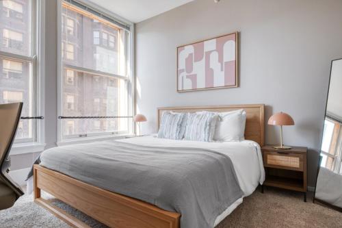 a bedroom with a large bed and two windows at Loop 2br w gym doorman nr L CHI-813 in Chicago
