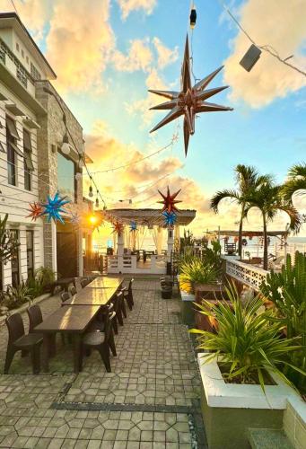a patio with tables and chairs and a star decoration at REEF HOUSE BACNOTAN White sand beach front with Private Swimming pool in Bacnotan