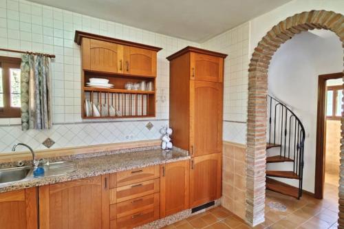 a kitchen with a sink and a stairway at Casa Sueño Español in Torrox