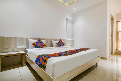 a bedroom with two beds in a room at FabHotel Blue Ocean in Indore
