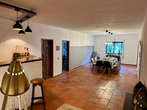 a dining room and living room with a table and chairs at Casa São José in Figueira da Foz