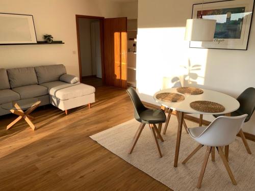 un soggiorno con tavolo, sedie e divano di Appartement Abendsonne a Rotenburg an der Fulda