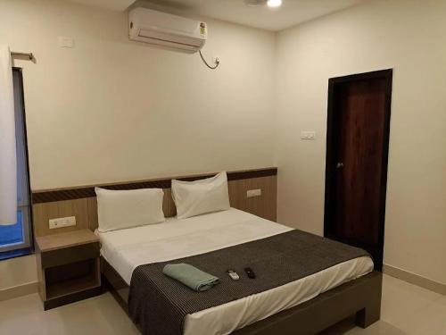 a bedroom with a bed and a air conditioner at Embassy Suites in Hyderabad