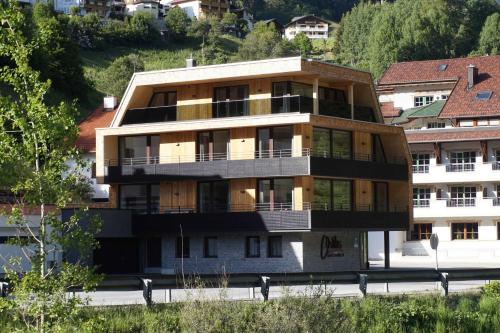 a building with balconies on the side of a street at C h illas Appartements in Kappl