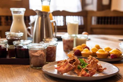 a plate of food on a wooden table at Herrenhaus im Artland in Ankum
