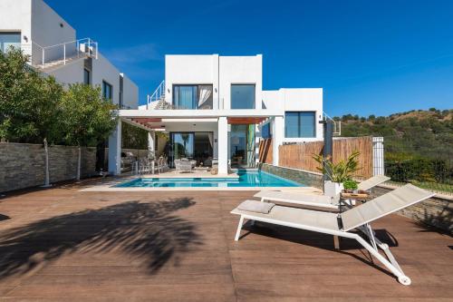 a villa with a swimming pool and a house at Amazing villa in Green Hill Marbella in Mijas