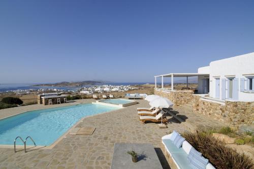 a villa with a swimming pool and a house at Villa St' Astra in Koufonisia