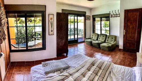 a living room with a bed and chairs in it at Casa La Caoba in Ruidera