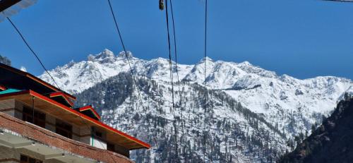 a view of a snow covered mountain at Snow View Guest House in Kasol