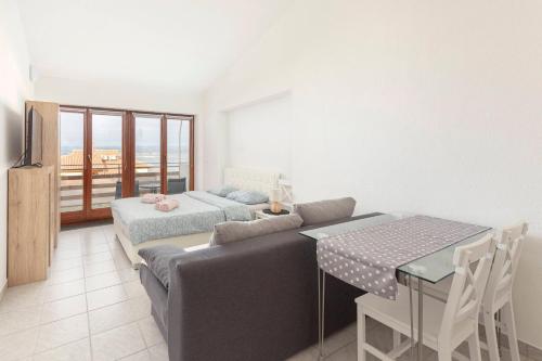 a living room with a couch and a table at Studio Vesna & Žan in Koper