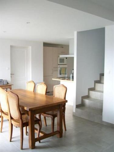 une salle à manger avec une table et des chaises en bois dans l'établissement Maison au calme avec vue sur mer 200 m de la mer, à Bretignolles-sur-Mer