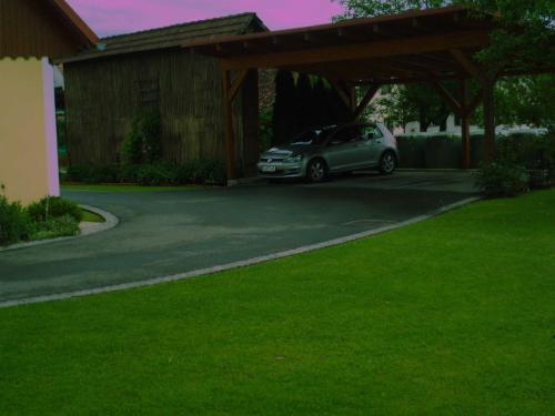 a car parked under a carport in a driveway at Ermi Pracher in Groß Sankt Florian