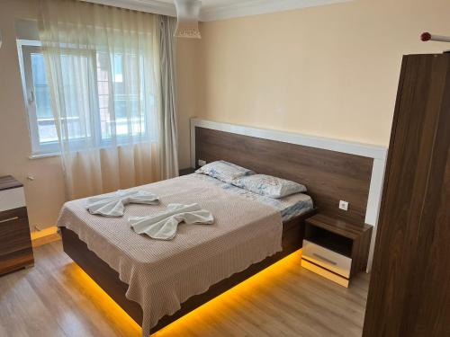 a bedroom with a bed with two towels on it at Pusula Apart Otel in Antalya