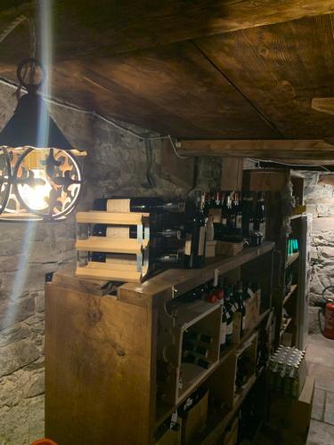 a room with a bunch of wine bottles on a shelf at Chalet del Lago in Ceresole Reale