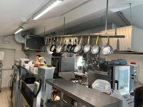 a kitchen with pots and pans hanging on the wall at Chalet del Lago in Ceresole Reale