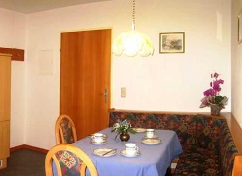 a room with a table and a couch with a blue table cloth at Chalet Sonnblick in Äußere Großrotte