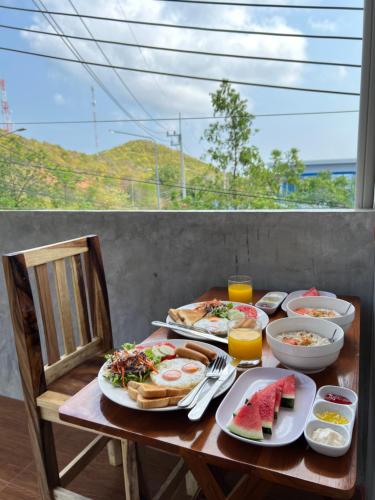 a wooden table with breakfast food on it at Samanta By The Hill in Ko Larn