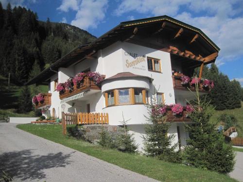 a building with flower boxes on the front of it at Chalet Sonnblick in Äußere Großrotte
