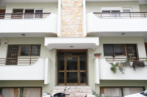 a building with a motorcycle parked in front of it at City Center Luxury Spacious apt A&M in Rhodes Town