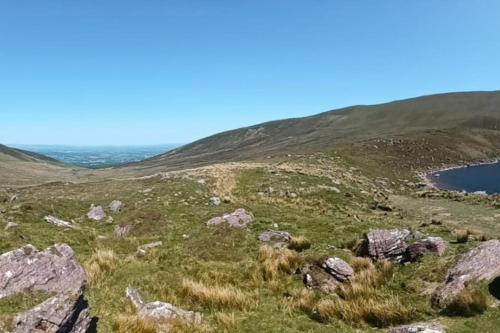 a view of a hill with rocks and a lake at Wood House Lodge in Tipperary