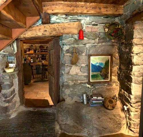 a stone wall with a painting on the wall at Chalet del Lago in Ceresole Reale