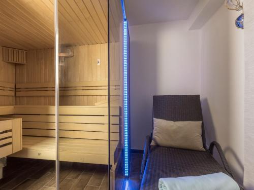 a sauna with a chair in a room at Appartementresidenz 4 Seasons in Timmendorfer Strand