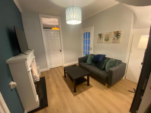 a living room with a couch and a table at Newly Furnished 5 Bedroom Gem in Sligo in Sligo