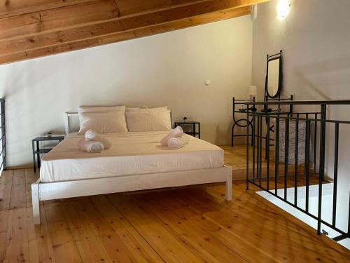 a bedroom with a bed with two pillows on it at Tsachaki Apartment Pigi Rethymno in Pigi