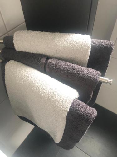 a group of towels on a rack in a bathroom at City Zen Apartment Enschede !Free Private Parking in Enschede