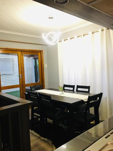a dining room with a table and chairs at Bella Hideaway Villa in East London