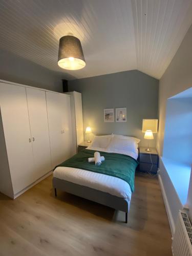 a bedroom with a bed with a teddy bear on it at Newly Furnished 5 Bedroom Gem in Sligo in Sligo
