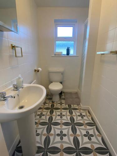 a bathroom with a sink and a toilet at Newly Furnished 5 Bedroom Gem in Sligo in Sligo