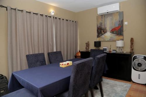 a dining room with a table and chairs with a box on it at AJ HOMES in Benin City