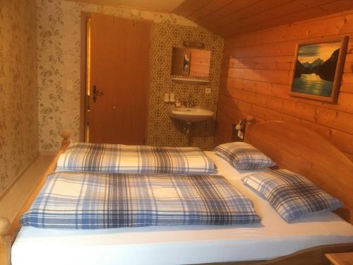 a bedroom with a bed and a sink at Planerhof in Görtschach