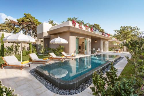 a villa with a swimming pool and a house at BIJAL in Side