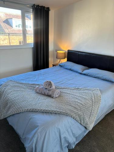 a bedroom with a bed with a towel on it at Nanny and Chips House in Whitby