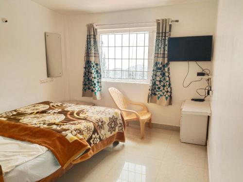 a bedroom with a bed and a window at dreams cottage in Ooty