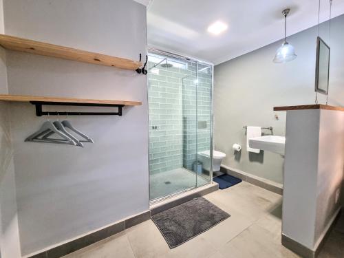 a bathroom with a shower and a toilet and a sink at 77 Chaka's Cove in Ballito