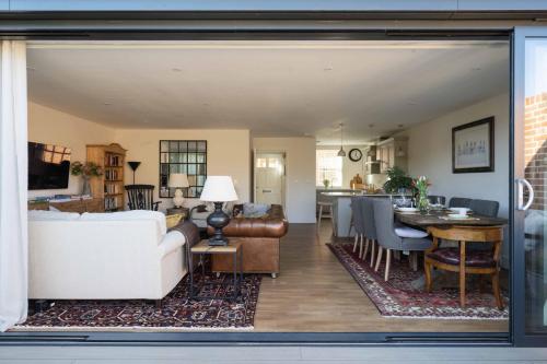 a living room with a couch and a table at Seabiscuit in Lymington