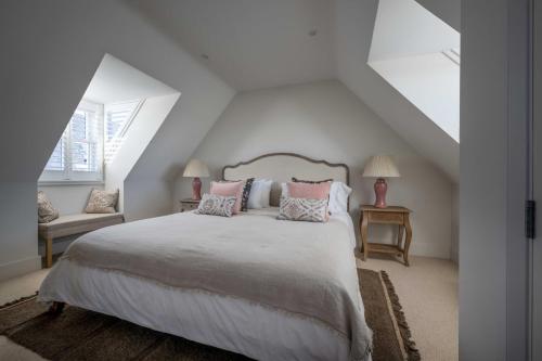 a bedroom with a large bed with pink pillows at Seabiscuit in Lymington