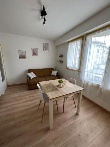 un salon avec une table et un canapé dans l'établissement Appartement centre-ville, vue sur la cathédrale, à Périgueux