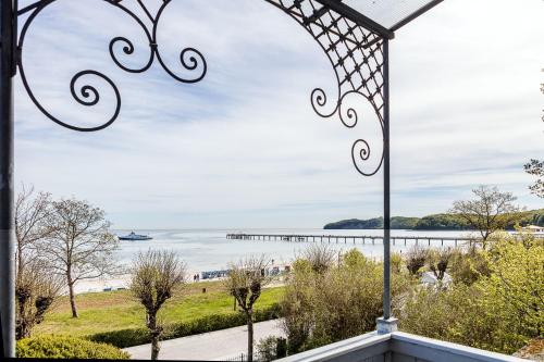a view of the ocean from a porch with a gate at Villa Ruscha in Binz
