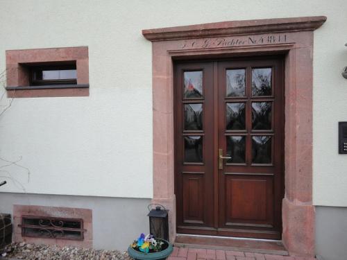 a wooden door on the side of a building at Ferienwohnung Rochlitzer Berg Blick in Seelitz