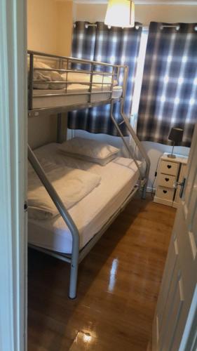 a couple of bunk beds in a room at MaterMolly Hemsby Chalet Hire 240 Belle aire beach road Hemsby NR29 4HZ in Hemsby