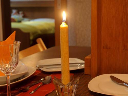 a candle sitting on top of a table next to a table sidx sidx sidx at Ferienwohnung Angelika in Bad Schallerbach