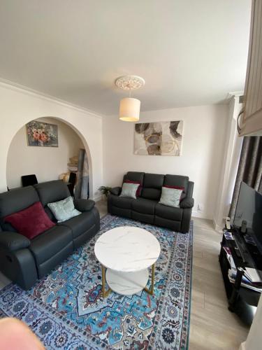 a living room with a couch and a table at 121 Spring Road in Kempston